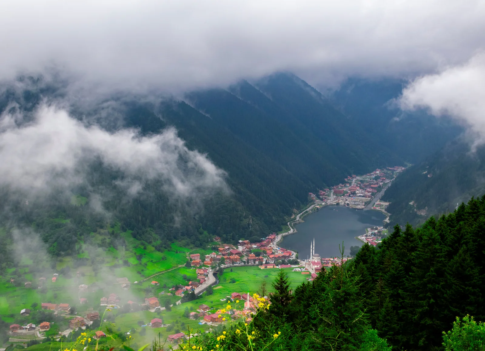 Reflective waters and wooden chalets around Uzungöl Lake